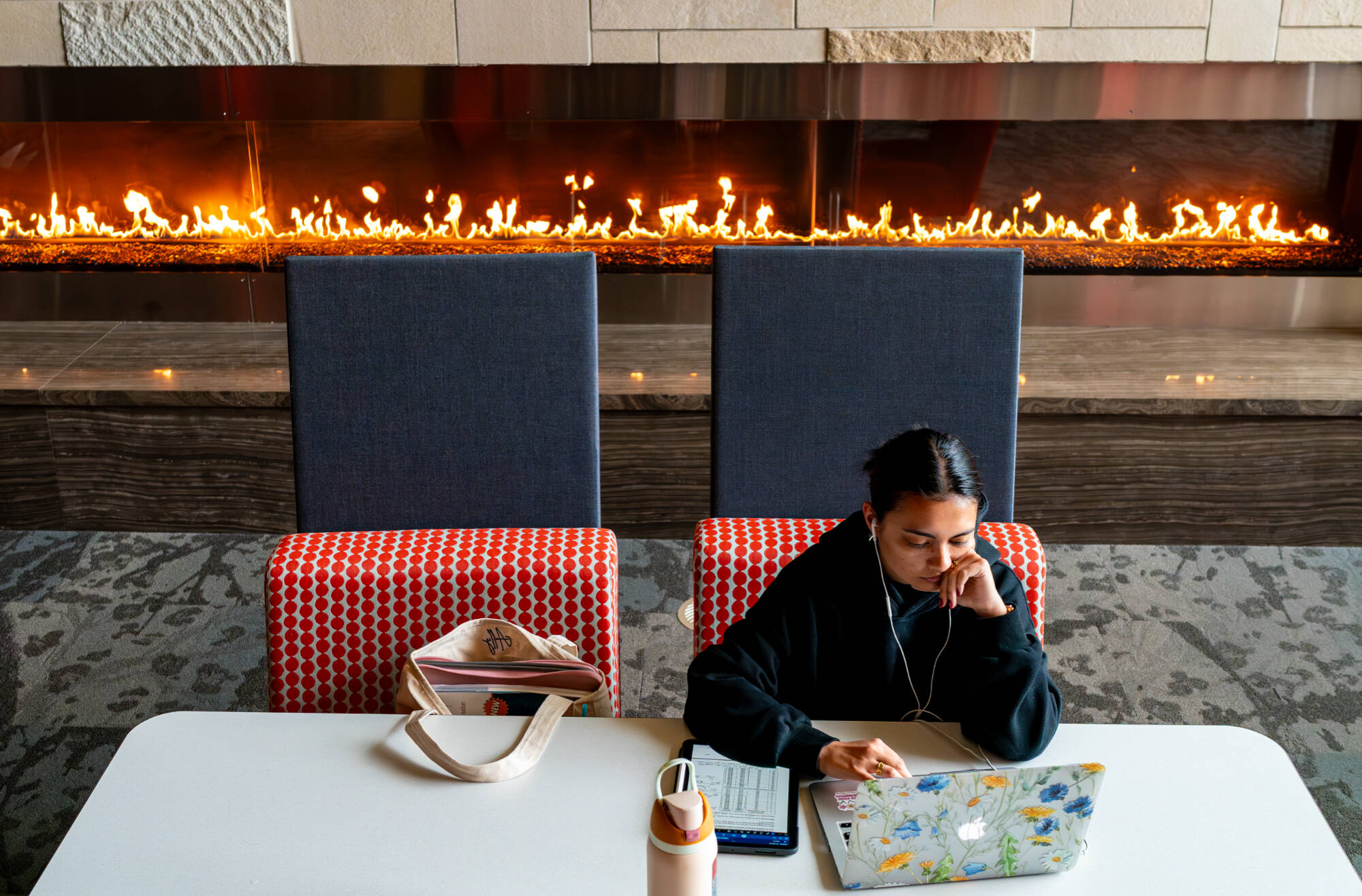 Speech-language pathology major Allison Booth studies near the 20-foot fireplace inside the third floor reading room at the Mary Idema Pew Library on May 20. Outside was 48 degrees with rainy weather.